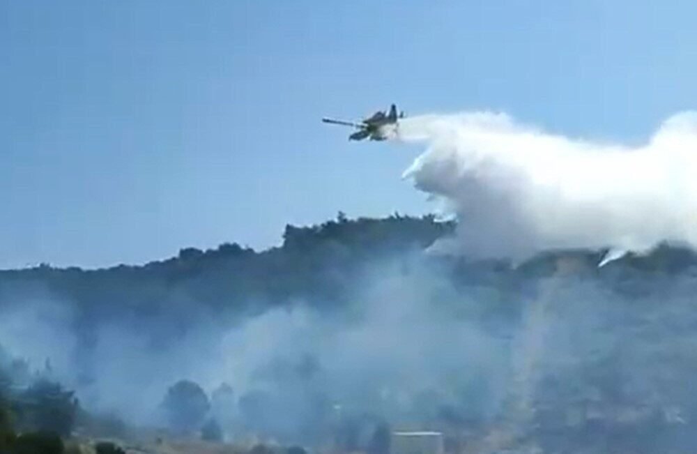 Aydın’ın Kuşadası ilçesinde orman yangını çıkarken, ekiplerin ve hava araçlarının